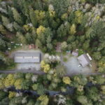Drone shot birds eye view of Charters Creek, Sooke River Jack Brooks Hatchery, and Charters River Salmon Interpretive Centre.