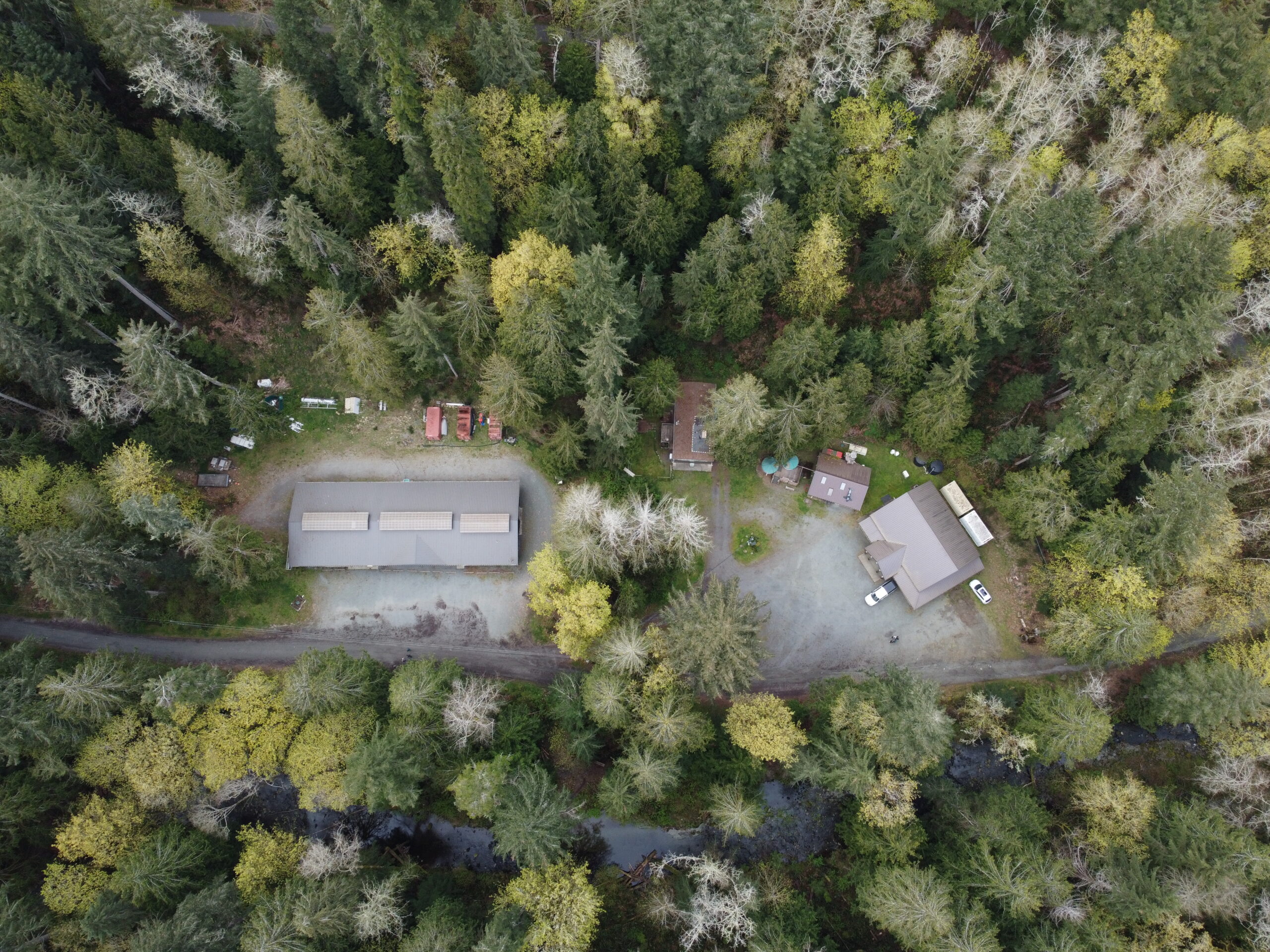 Drone shot birds eye view of Charters Creek, Sooke River Jack Brooks Hatchery, and Charters River Salmon Interpretive Centre.