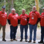 Sooke Salmon Enhancement Society volunteers at Sooke River Jack Brooks hatchery with the forest behind them